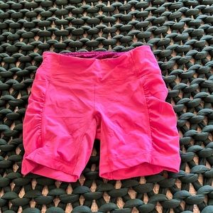Lululemon speed track shorts in bright pink.